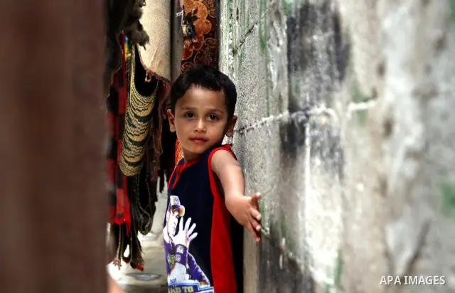 A Palestinian boy plays in front of their house in the Jabaliya refugee camp in the northern area of the Gaza Strip on June 20, 2011. Reports state that the Islamic militant group Hamas is weighing a new strategy of not...