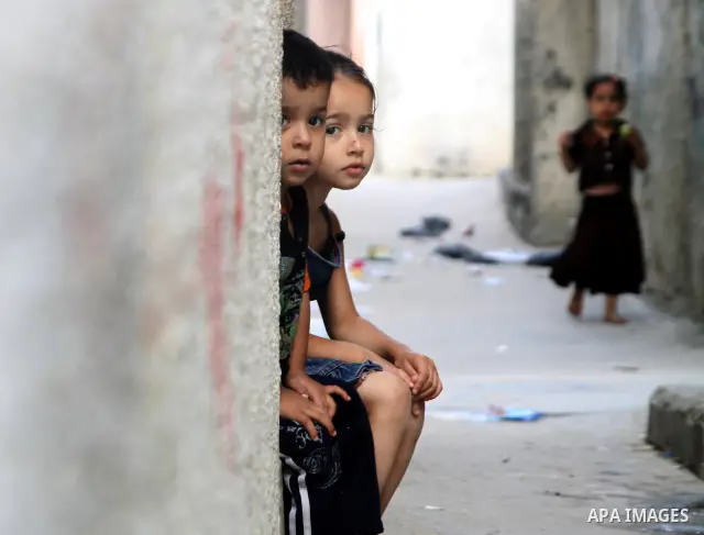Palestinian children play in front of their house in the Jabaliya refugee camp in the northern area of the Gaza Strip on June 20, 2011. Reports state that the Islamic militant group Hamas is weighing a new strategy of no...