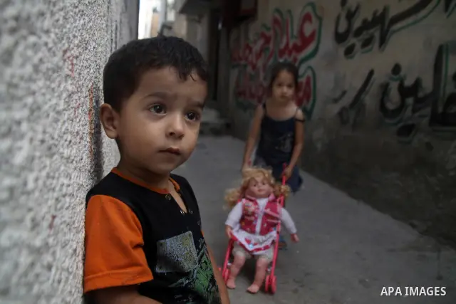 Palestinian children play in front of their house in the Jabaliya refugee camp in the northern area of the Gaza Strip on June 20, 2011. Reports state that the Islamic militant group Hamas is weighing a new strategy of no...