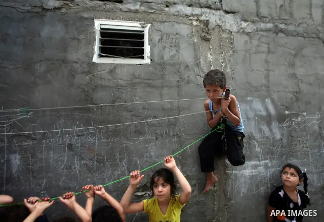 Palestinian children play in front of their house in the Jabaliya refugee camp in the northern area of the Gaza Strip on June 20, 2011. Reports state that the Islamic militant group Hamas is weighing a new strategy of no...