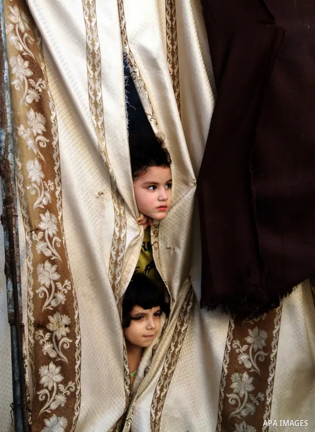 Palestinian children play in front of their house in the Jabaliya refugee camp in the northern area of the Gaza Strip on June 20, 2011. Reports state that the Islamic militant group Hamas is weighing a new strategy of no...