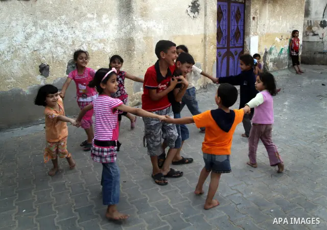 Palestinian children play in front of their house in the Jabaliya refugee camp in the northern area of the Gaza Strip on June 20, 2011. Reports state that the Islamic militant group Hamas is weighing a new strategy of no...