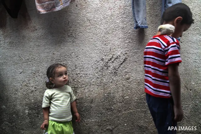 Palestinian children play in front of their house in the Jabaliya refugee camp in the northern area of the Gaza Strip on June 20, 2011. Reports state that the Islamic militant group Hamas is weighing a new strategy of no...