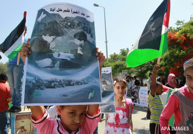 Palestinian children attending a summer camp hold up signs during a protest to mark "nakba" or "catastrophe" of Israel's 1948 creation, on June 20, 2011 in Gaza City. Photo by Naaman Omar