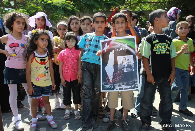 Palestinian children attending a summer camp hold up signs during a protest to mark "nakba" or "catastrophe" of Israel's 1948 creation, on June 20, 2011 in Gaza City. Photo by Naaman Omar