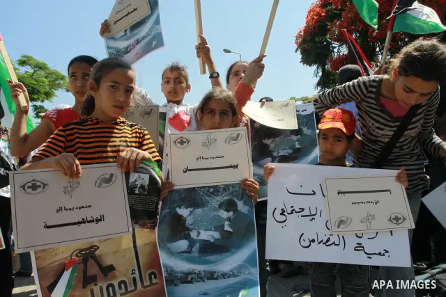 Palestinian children attending a summer camp hold up signs during a protest to mark "nakba" or "catastrophe" of Israel's 1948 creation, on June 20, 2011 in Gaza City. Photo by Naaman Omar