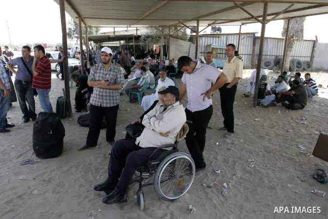 Palestinians wait to cross into Egypt through the Rafah border crossing in the southern Gaza Strip on June 20, 2011. Photo by Abed Rahim Khatib