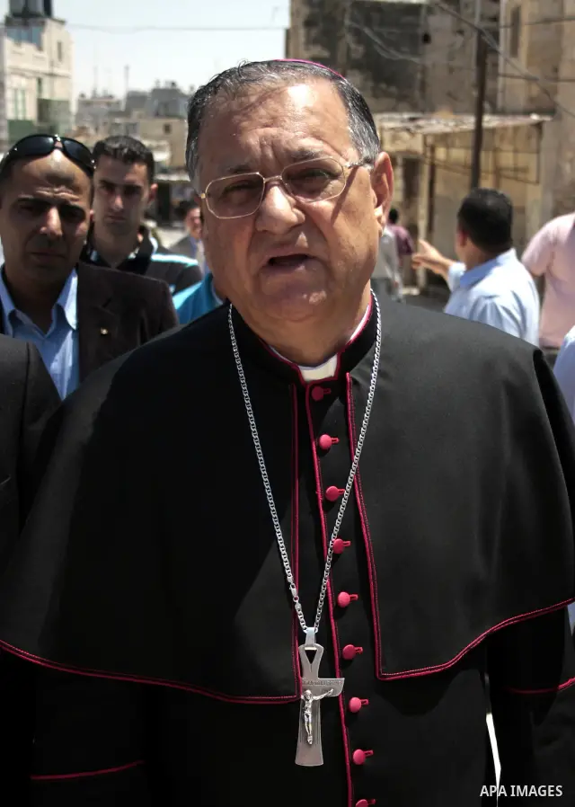 The head of the Roman Catholic Church in the Holy Land, the Latin Patriarch of Jerusalem Fuad Twal walks among Palestinian officials near the Ibrahimi Mosque, or Tomb of the Patriarchs, during a visit to the divided West...