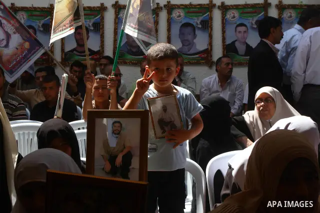 Palestinians hold pictures of their jailed relatives during a protest outside the Red Cross' offices in Gaza City calling for the release of Palestinian prisoners held in Israeli jails, on June 20, 2011. Photo by Ashraf...