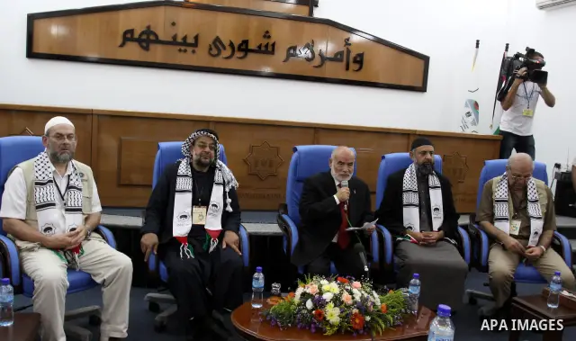 The spokesman of the Palestinian parliament, Ahmed Bahr meets with members of the "Miles of Smiles 3" aid convoy at the parliament headquarters in Gaza city on Jun 21,2011. The convoy, carrying medical aid for the impove...