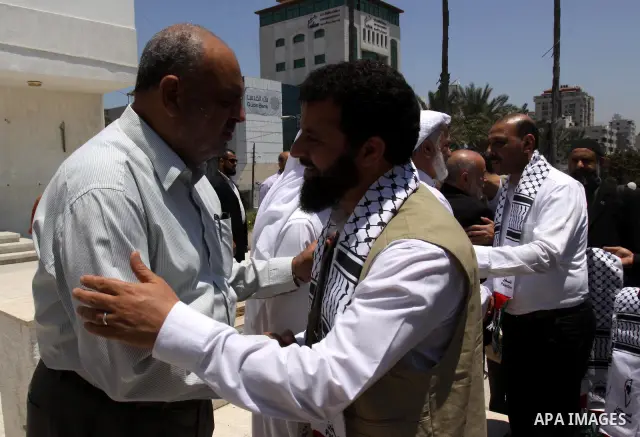 The spokesman of the Palestinian parliament, Ahmed Bahr meets with members of the "Miles of Smiles 3" aid convoy at the parliament headquarters in Gaza city on Jun 21,2011. The convoy, carrying medical aid for the impove...