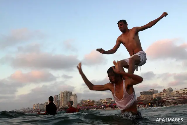 Palestinians enjoy swimming in the sea on Gaza's beach on June 21, 2011 in Gaza City. Photo by Mohammed Asad