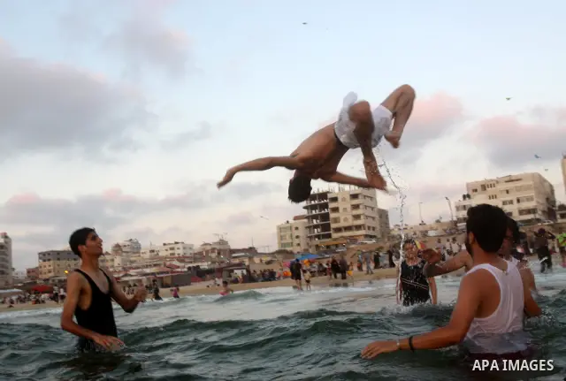 Palestinians enjoy swimming in the sea on Gaza's beach on June 21, 2011 in Gaza City. Photo by Mohammed Asad