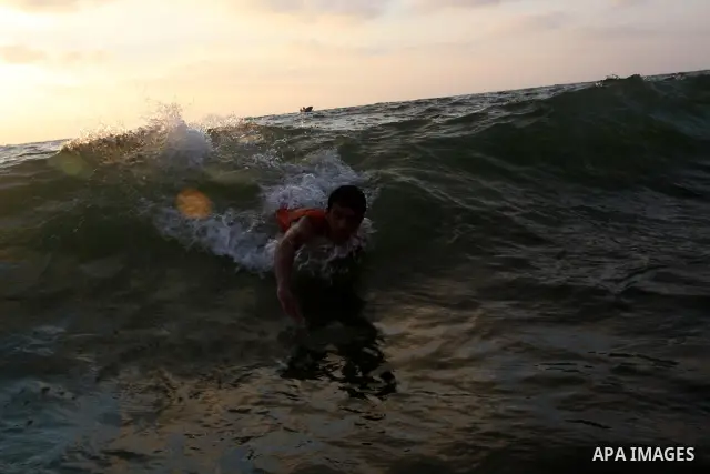 Palestinians enjoy swimming in the sea on Gaza's beach on June 21, 2011 in Gaza City. Photo by Mohammed Asad