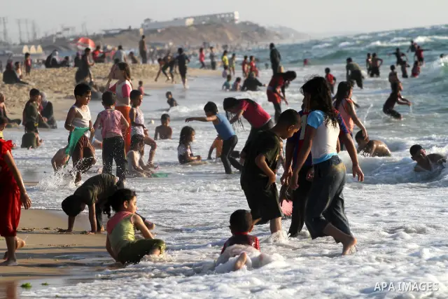 Palestinians enjoy swimming in the sea on Gaza's beach on June 21, 2011 in Gaza City. Photo by Mohammed Asad