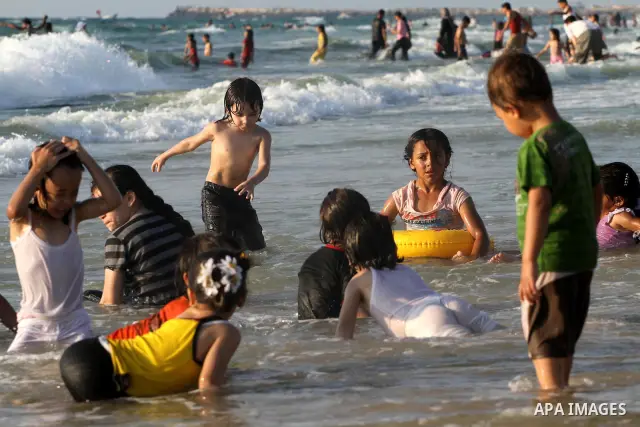 Palestinians enjoy swimming in the sea on Gaza's beach on June 21, 2011 in Gaza City. Photo by Mohammed Asad