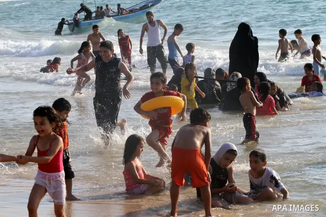 Palestinians enjoy swimming in the sea on Gaza's beach on June 21, 2011 in Gaza City. Photo by Mohammed Asad