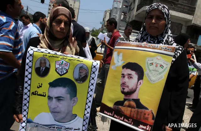 Palestinian women holding pictures of their jailed relatives attend a protest calling for the release of Palestinian prisoners from Israeli jails , in Gaza City on June 23, 2011, as 7,500 Palestinian prisoners are held i...