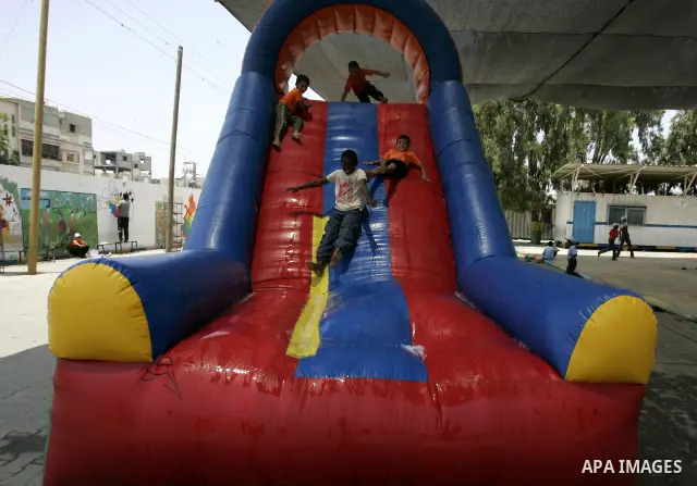Palestinian boys play at a summer camp organised by UNRWA in Rafah, southern Gaza Strip on Jun 23, 2011. Photo by Abed Rahim Khatib