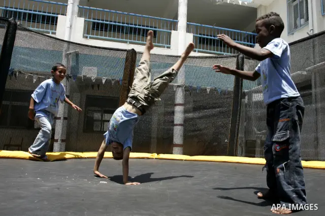 Palestinian boys play at a summer camp organised by UNRWA in Rafah, southern Gaza Strip on Jun 23, 2011. Photo by Abed Rahim Khatib