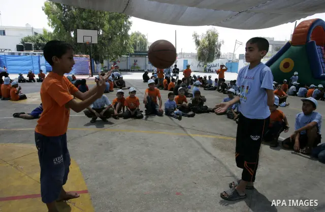 Palestinian boys play at a summer camp organised by UNRWA in Rafah, southern Gaza Strip on Jun 23, 2011. Photo by Abed Rahim Khatib