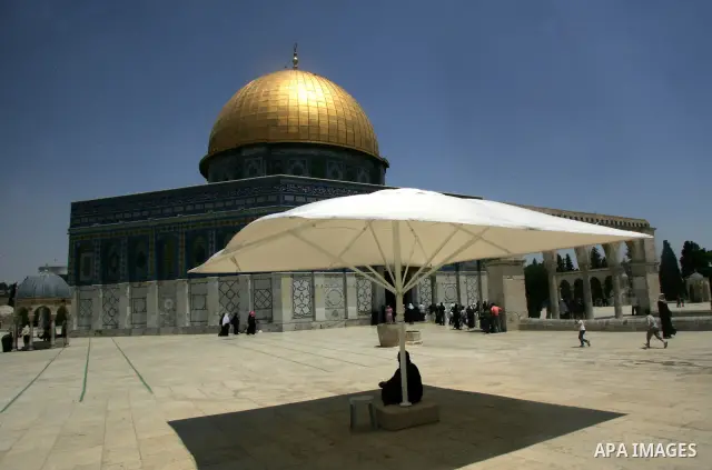 Palestinian Muslim worshippers walk outside the Dome of the Rock at the Al-Aqsa Mosques compound in Jerusalem's Old City on Jun 23, 2011. Photo by Mahfouz Abu Turk