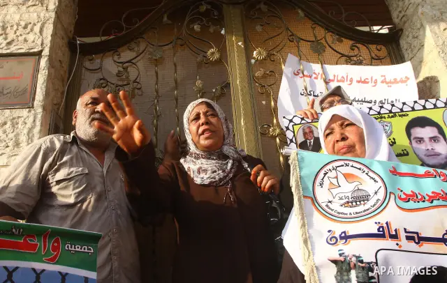 Palestinian prisoners relatives protest outside the International Committee of the Red Cross (ICRC) as dozens of angry protesters demonstrated outside the premises of the ICRC in Gaza City on June 23, 2011 against a call...