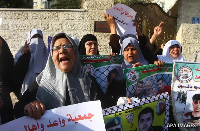 Palestinian prisoners relatives protest outside the International Committee of the Red Cross (ICRC) as dozens of angry protesters demonstrated outside the premises of the ICRC in Gaza City on June 23, 2011 against a call...