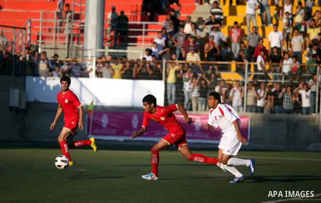 Palestinian team's player challenges the Bahrain's player during their 2012 Olympic qualifying football match in the West Bank town of Al-Ram, near Ramallah, on June 23, 2011 . Photo by Issam Rimawi