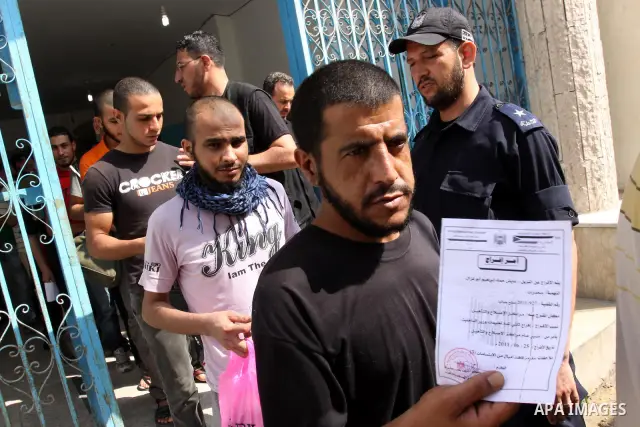 Palestinian prisoners prepare to be freed from a Hamas-run jail in Gaza City on June 25, 2011. Palestinian Hamas policemen released 26 prisoners in the presence of the convoy of "Miles of Smiles 3". Photo by Mohammed Asa...