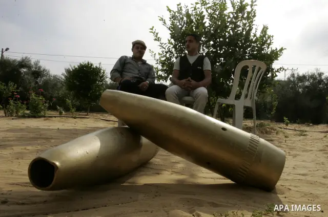 Two Palestinian men retain the missiles did not explode in their house as a form of art in the east of Khan Younis in the southern Gaza Strip on June 25, 2011. The Red Cross called on Hamas on 23 June 2011 to provide pro...