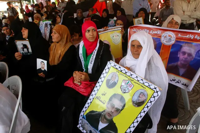 Palestinian women hold pictures of relatives during a protest calling for the release of Palestinian prisoners from Israeli jails in front of the Red Cross in Gaza city on June 26, 2011. Photo by Ashraf Amra