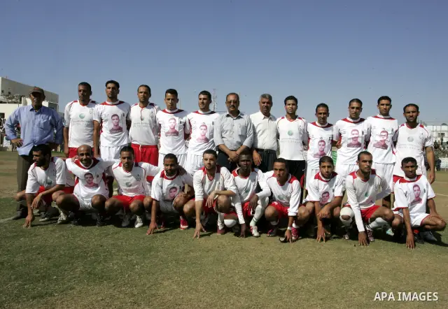 Palestinian football players prepare for a football match between Khan Yunis Youth club (red shirt) and Rafah Collective club (white shirt) on Jun 27, 2011 in the southern Gaza Strip town of Rafah. Photo by Abed Rahim Kh...