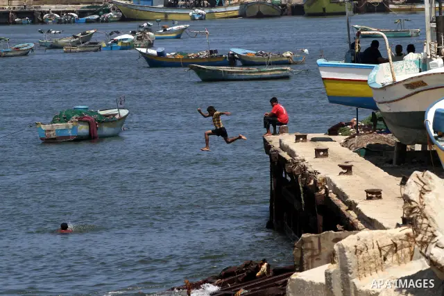 Palestinian boys enjoy in the port of Gaza at the end of the preparations to receive the Freedom flotilla "2" in Gaza city on June 28, 2011. Photo by Mohammed Asad