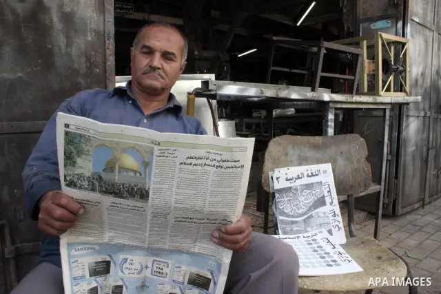 A Palestinian elderly man Elias Abdel-Hay prepares to study in the high school "Twajihi" after he left studing for 47 years in the West Bank city of Hebron on June 29, 2011. Where he completed the ninth-grade for the las...
