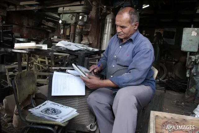 A Palestinian elderly man Elias Abdel-Hay prepares to study in the high school "Twajihi" after he left studing for 47 years in the West Bank city of Hebron on June 29, 2011. Where he completed the ninth-grade for the las...
