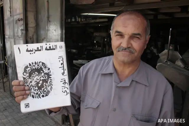 A Palestinian elderly man Elias Abdel-Hay prepares to study in the high school "Twajihi" after he left studing for 47 years in the West Bank city of Hebron on June 29, 2011. Where he completed the ninth-grade for the las...
