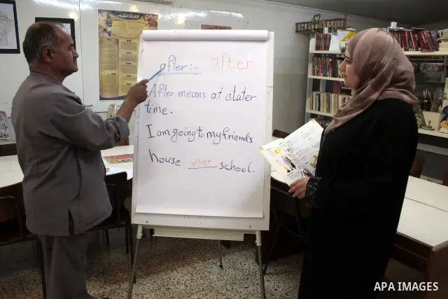 A Palestinian elderly man Elias Abdel-Hay prepares to study in the high school "Twajihi" after he left studing for 47 years in the West Bank city of Hebron on June 29, 2011. Where he completed the ninth-grade for the las...