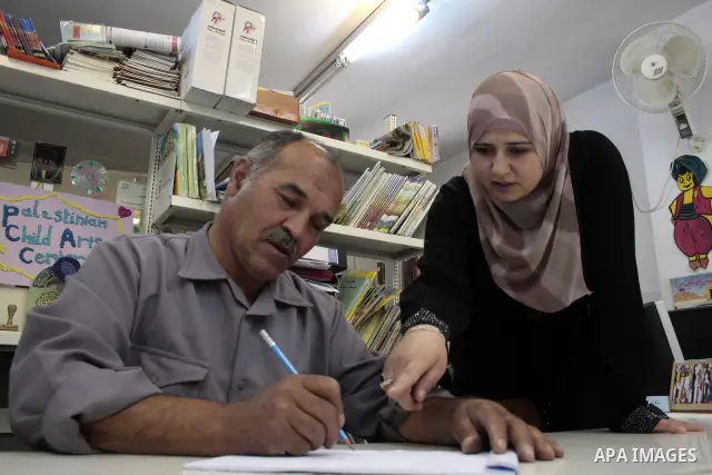 A Palestinian elderly man Elias Abdel-Hay prepares to study in the high school "Twajihi" after he left studing for 47 years in the West Bank city of Hebron on June 29, 2011. Where he completed the ninth-grade for the las...