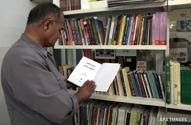 A Palestinian elderly man Elias Abdel-Hay prepares to study in the high school "Twajihi" after he left studing for 47 years in the West Bank city of Hebron on June 29, 2011. Where he completed the ninth-grade for the las...