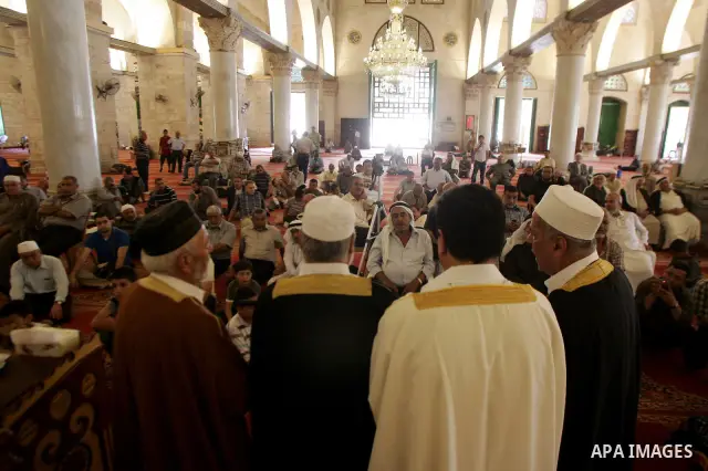 Palestinian men perform nashed (Islamic songs) to mark the anniversary of Al-Isra wa Al-Mearaj inside the Al-Aqsa Mosque in Jerrusalem's old city on June 29, 2011 to prepare it for the fitting of a new carpet. According...