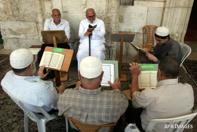 Palestinians read Holy Koran inside the Al-Aqsa Mosque in Jerrusalem's old city on June 29, 2011. According to Sheikh Azzam Khatib, the head of the Islamic Waqf in Jerusalem, work have started to fit 5000 square meters o...