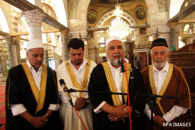 Palestinian men perform nashed (Islamic songs) to mark the anniversary of Al-Isra wa Al-Mearaj inside the Al-Aqsa Mosque in Jerrusalem's old city on June 29, 2011 to prepare it for the fitting of a new carpet. According...