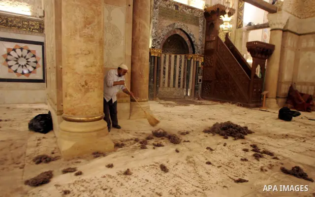 A Palestinian man cleans the floor inside the Al-Aqsa Mosque in Jerrusalem's old city on June 29, 2011 to prepare it for the fitting of a new carpet. According to Sheikh Azzam Khatib, the head of the Islamic Waqf in Jeru...