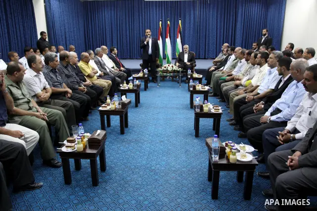 Palestinian Prime Minister in Gaza strip, Ismail Haniya meets with Palestinian Minister of Youth and Sports, Muhammad Al-Mahdhou, during honoring the Khan Younis football team in his office in Gaza city on June 30, 2011....