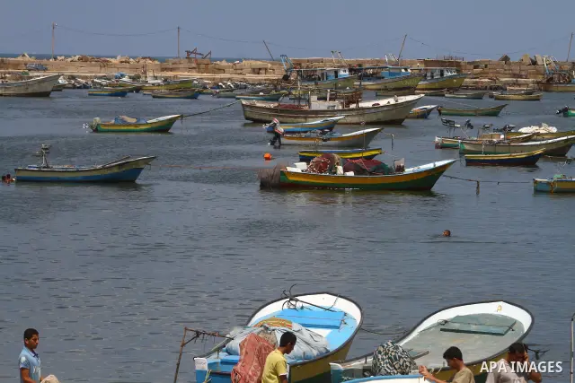 Palestinians gather in the port of Gaza during the end of the preparations to support the Freedom flotilla "2" in Gaza city on June 30, 2011. at the site of a monument (unseen) built to commemorate the first anniversary...