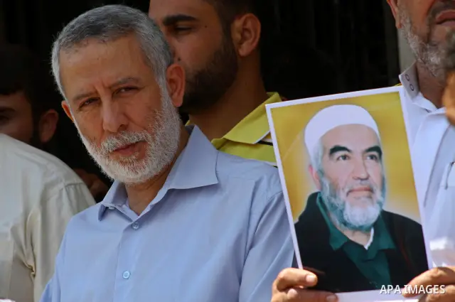 Supporters of Sheikh Raed Salah (portrait), head of the radical wing of the Islamic Movement in Israel, demonstrate in Gaza City on June 30, 2011 after the controversial Arab-Israeli Islamist leader was arrested in Londo...