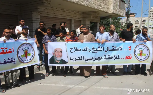 Supporters of Sheikh Raed Salah (portrait), head of the radical wing of the Islamic Movement in Israel, demonstrate in Gaza City on June 30, 2011 after the controversial Arab-Israeli Islamist leader was arrested in Londo...
