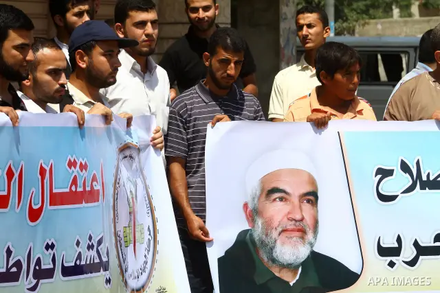 Supporters of Sheikh Raed Salah (portrait), head of the radical wing of the Islamic Movement in Israel, demonstrate in Gaza City on June 30, 2011 after the controversial Arab-Israeli Islamist leader was arrested in Londo...