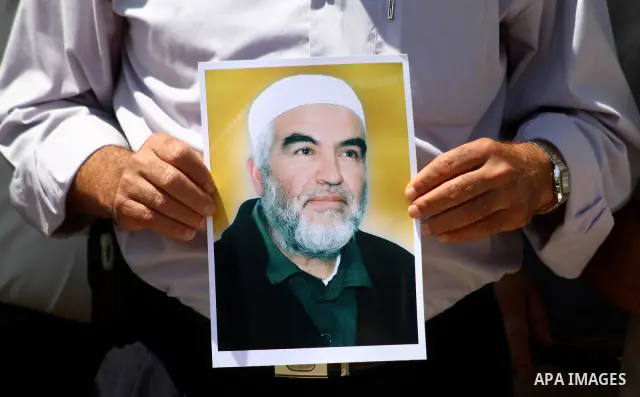 Supporters of Sheikh Raed Salah (portrait), head of the radical wing of the Islamic Movement in Israel, demonstrate in Gaza City on June 30, 2011 after the controversial Arab-Israeli Islamist leader was arrested in Londo...